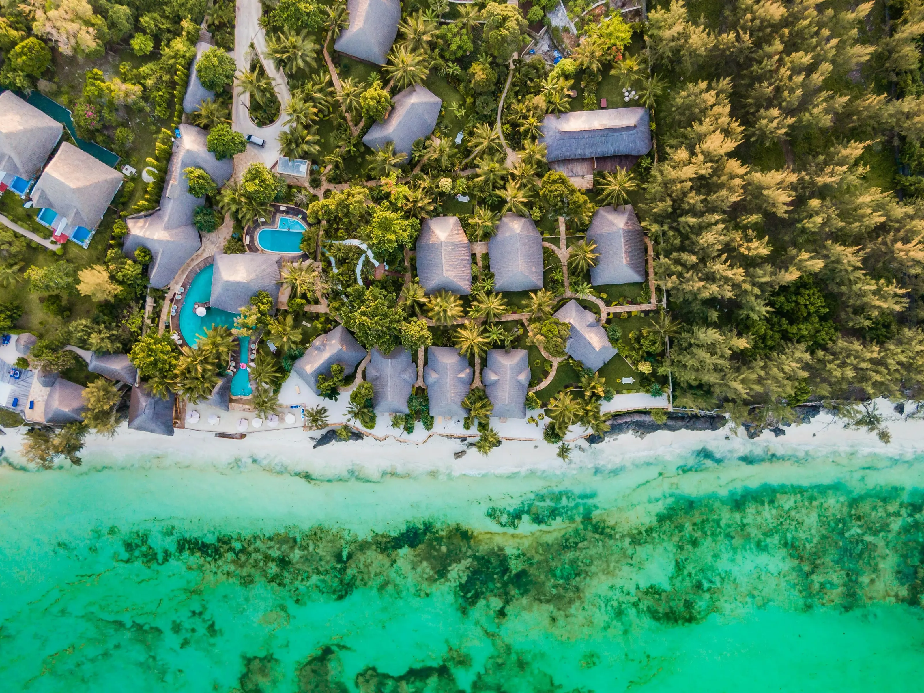 A top-down view of a beachfront and jungle resort