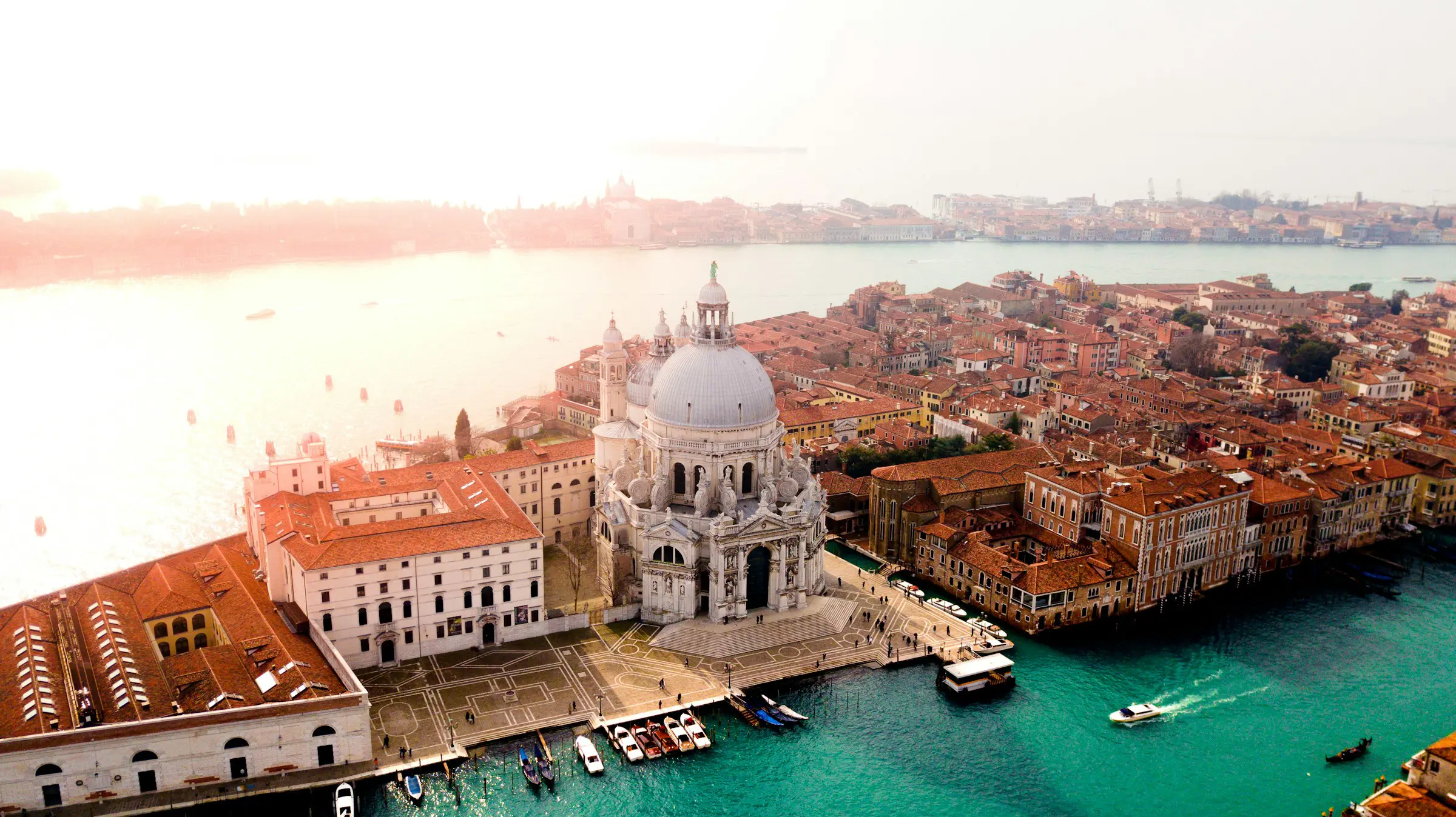 Sunset over Venice with a view from above as the sea meets the city
