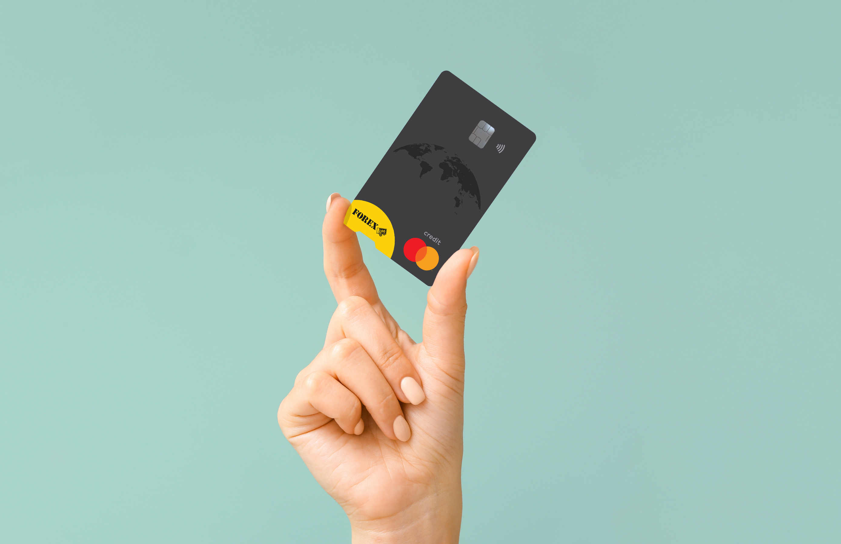 Hand holding a black FOREX credit card against green background.