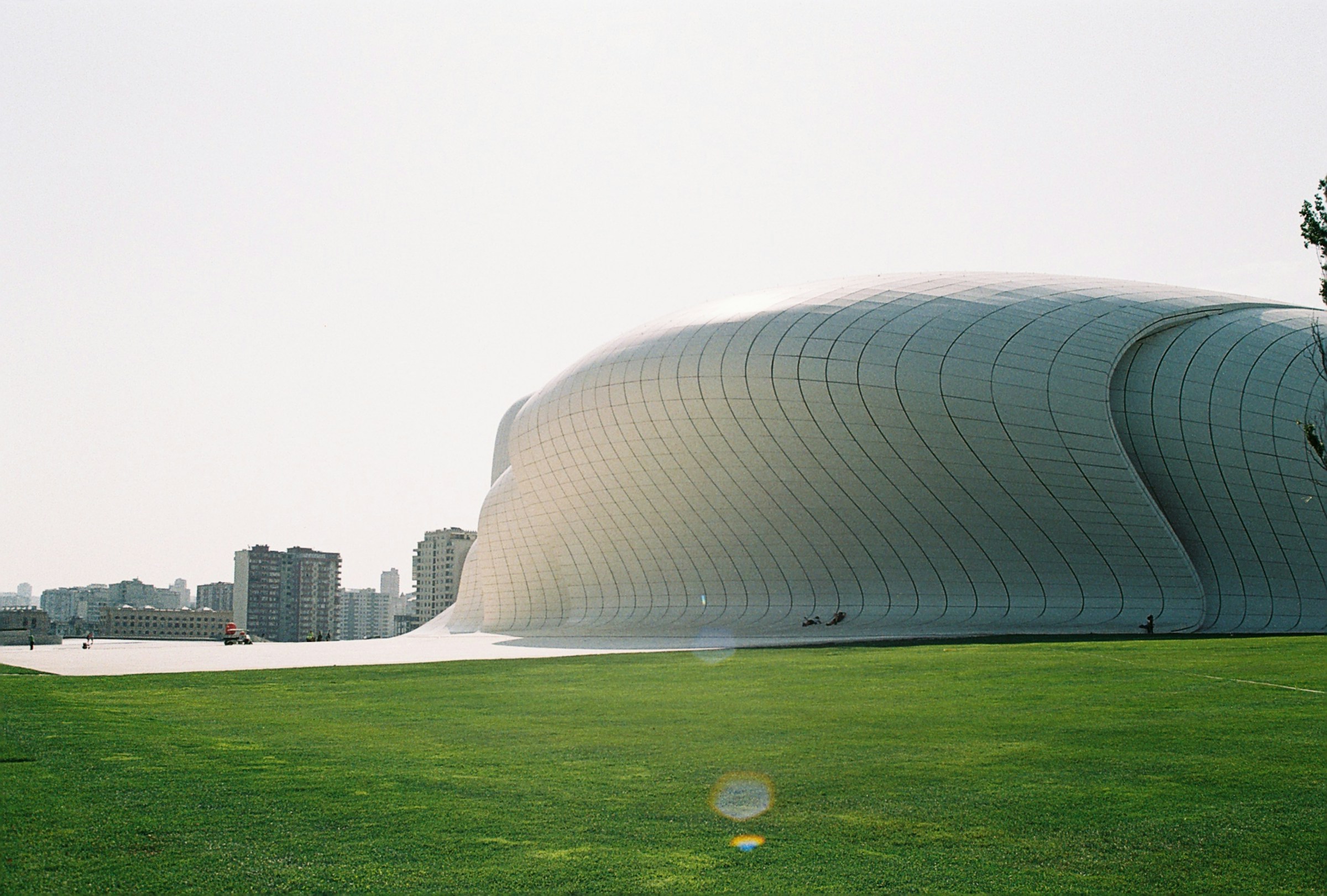 Famous Artistic Curved Metal Building in Baku with Green Lawn Around It