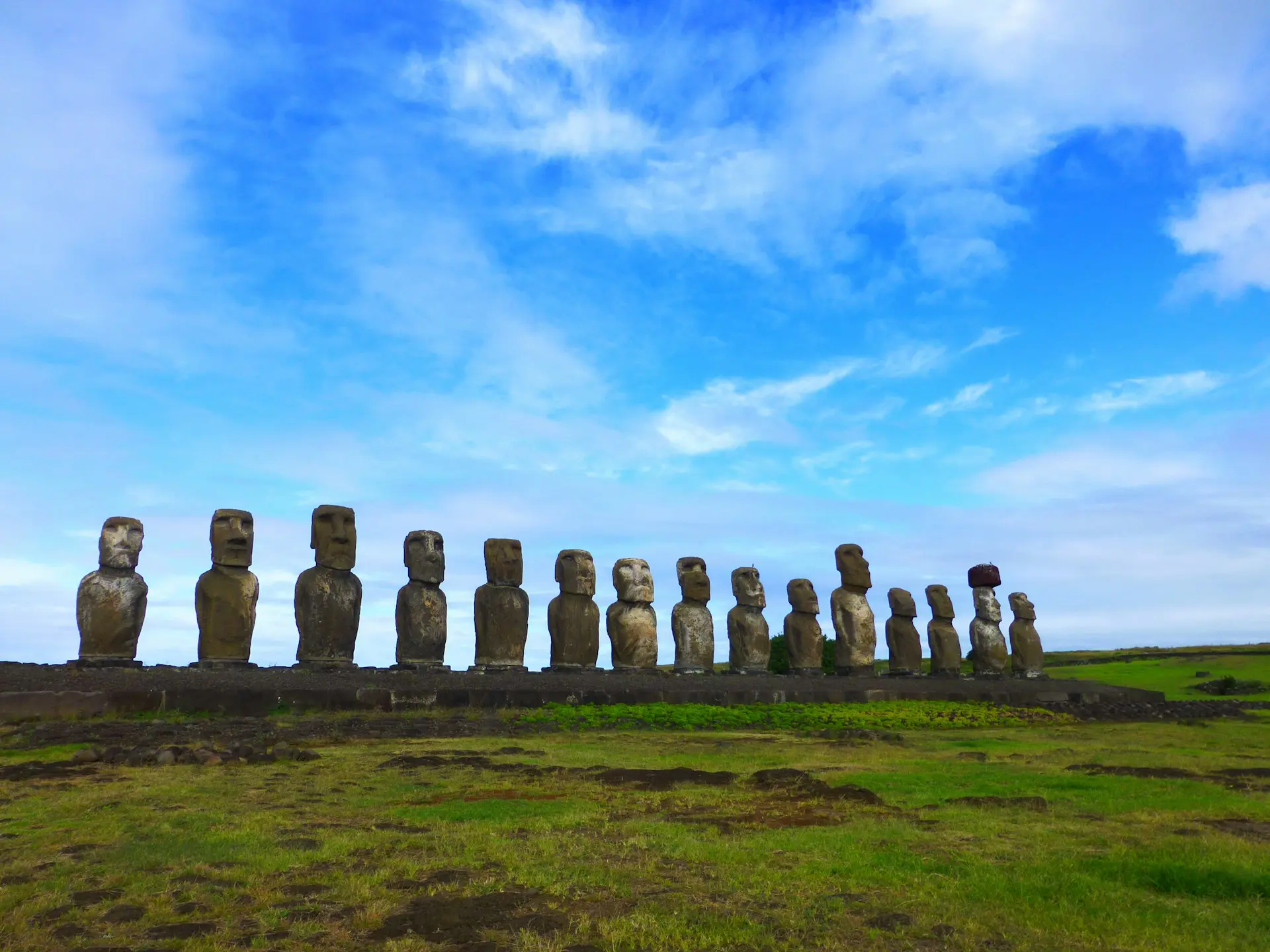Moai statues on Ahu Tongariki against a blue sky on Easter Island.