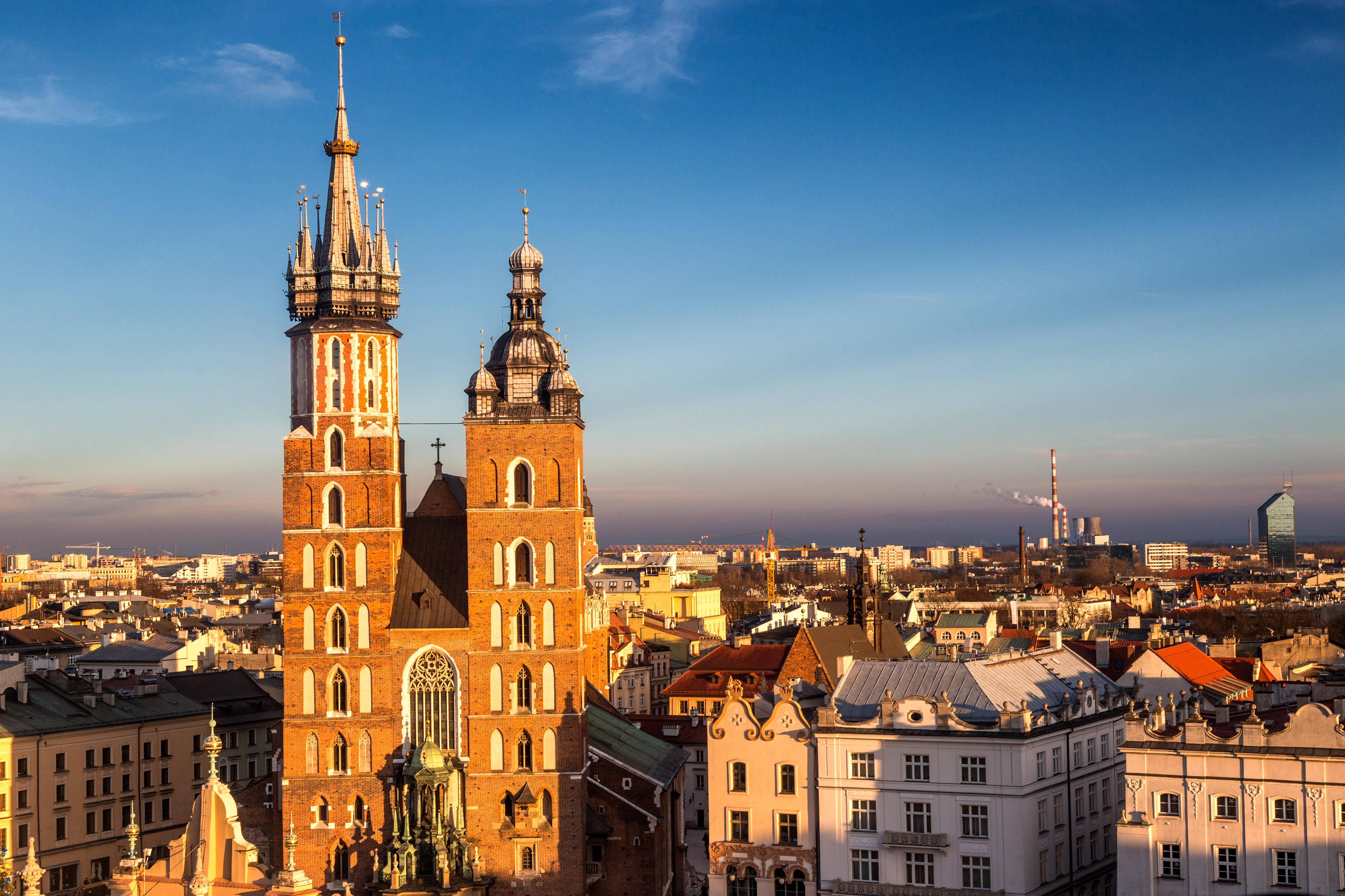St. Mary's Basilica in Kraków, Poland, with its iconic towers and Gothic architecture under a clear blue sky