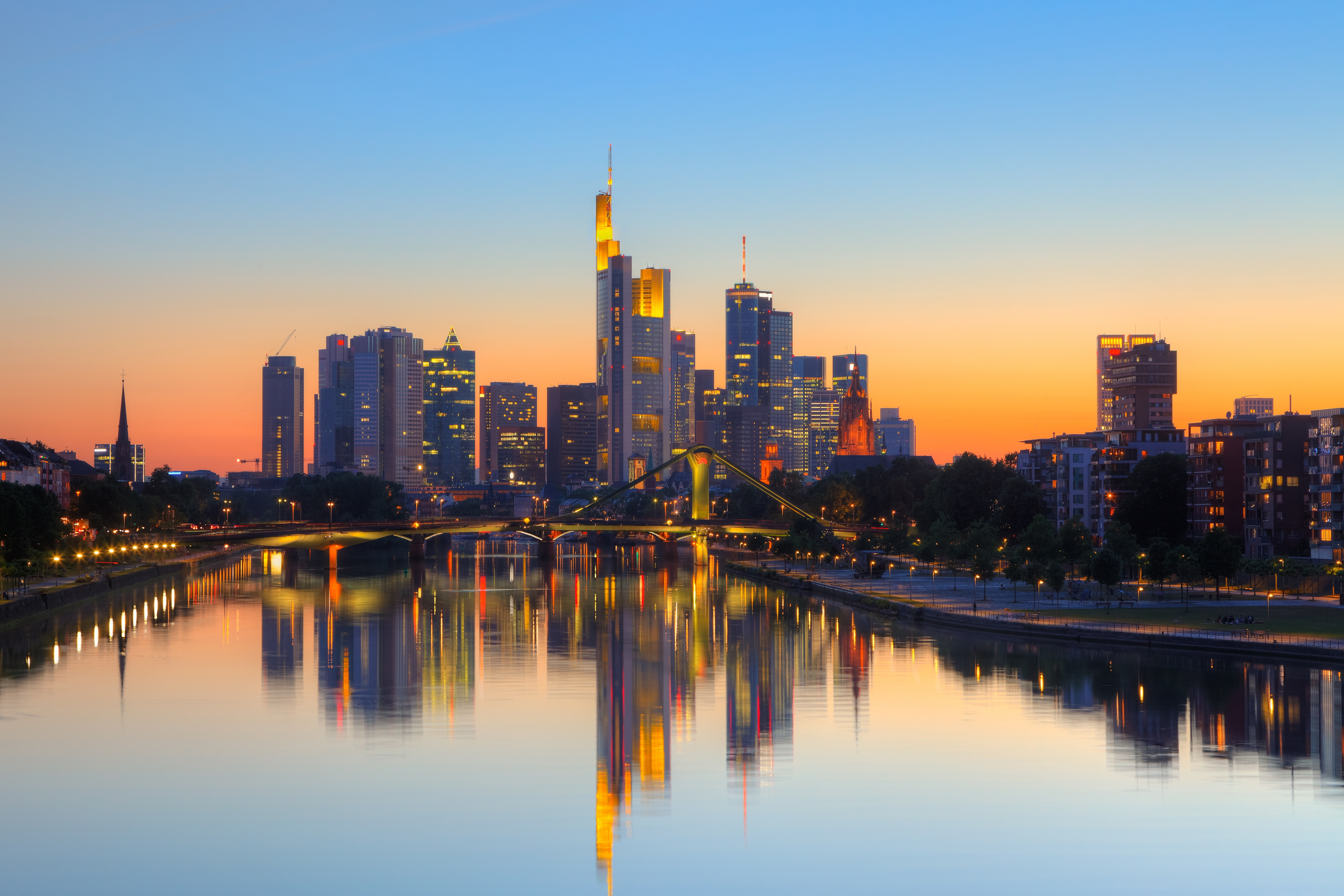 Frankfurt city skyline at sunset with skyscrapers reflecting in the Main River, Germany